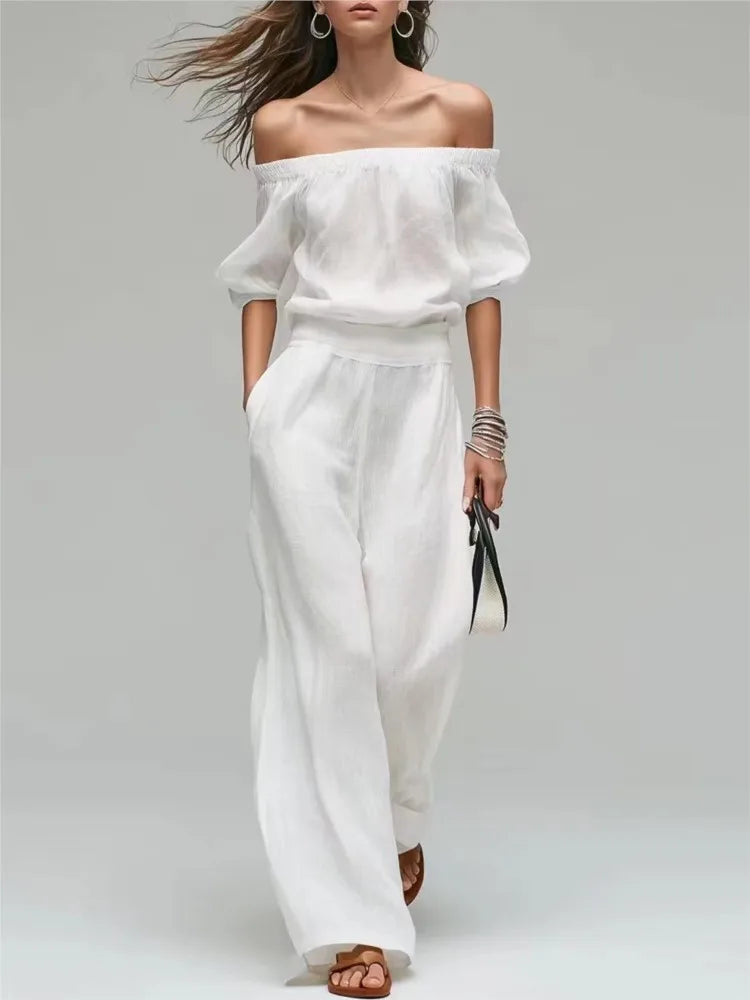 Conjunto de 2 piezas de verano: top de un solo hombro con cintura ajustada y pantalón de pierna ancha. Diseño elegante y moderno en color liso, ideal para looks casuales, vacaciones y fiestas.